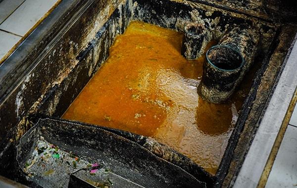 procrastinating on grease trap cleaning can cause clogs, foul odors, and even sewage backups